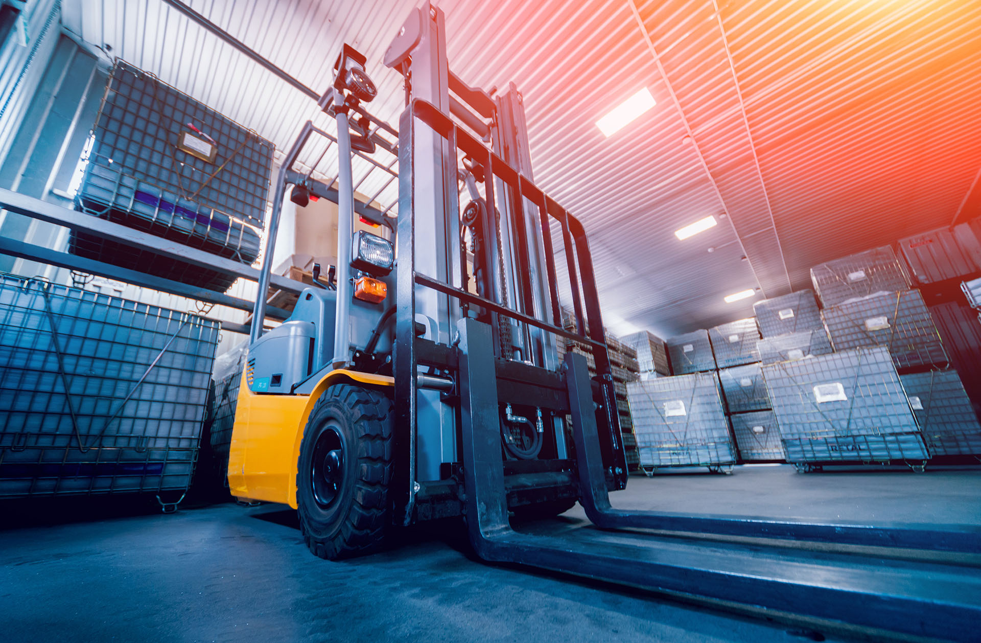 A forklift truck standing in a warehouse